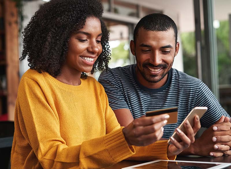 couple buying with credit card on phone